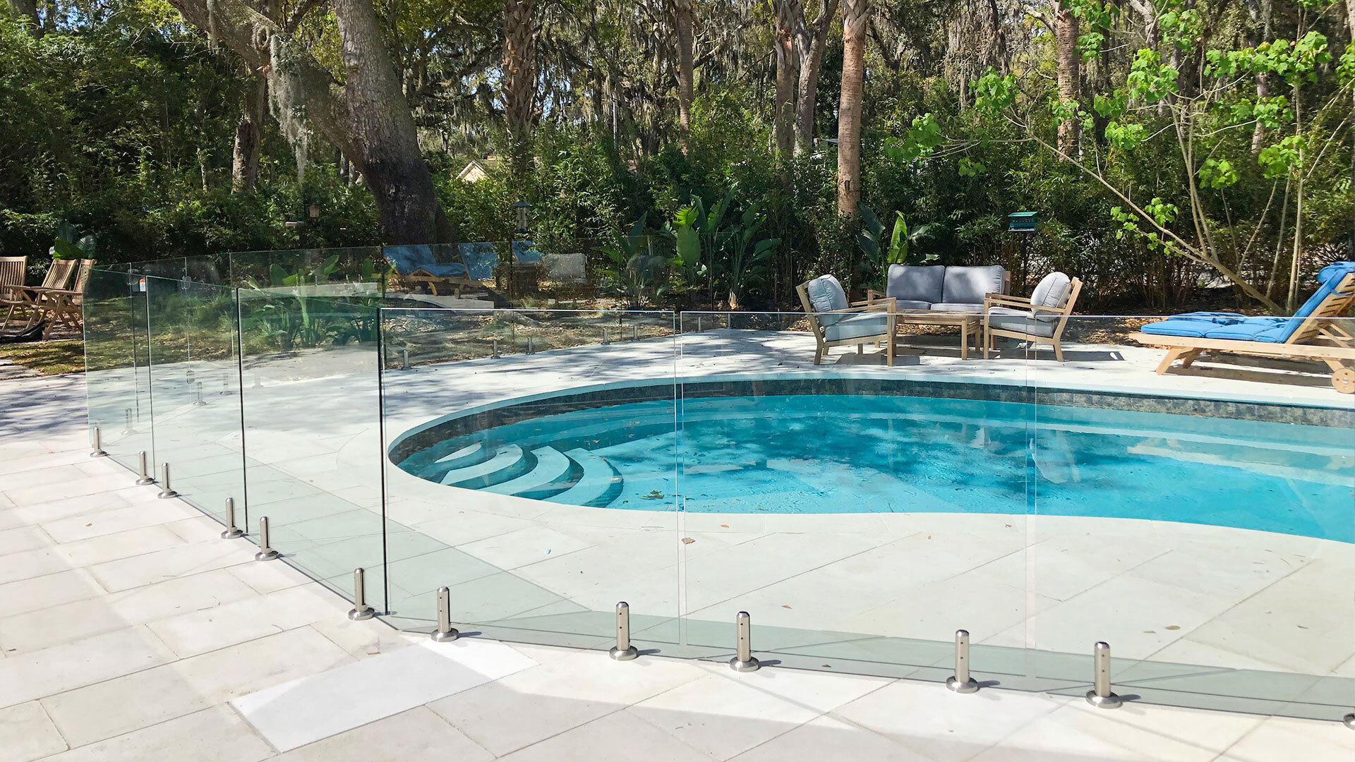 Residential glass pool fence around a luxury home